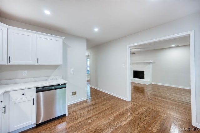 1436 Porters Mill Ter, Chesterfield, VA 23114 - kitchen with stainless steel dishwasher, light wood-type flooring, white cabinetry, a brick fireplace, and recessed lighting