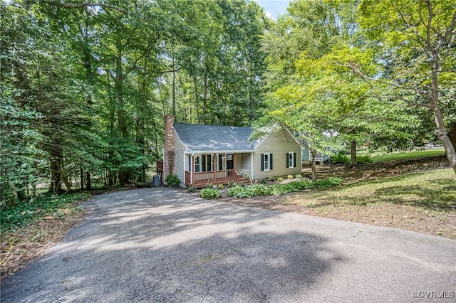 1436 Porters Mill Ter, Chesterfield, VA 23114 - view of front of house with asphalt driveway, covered porch, a chimney, and roof with shingles