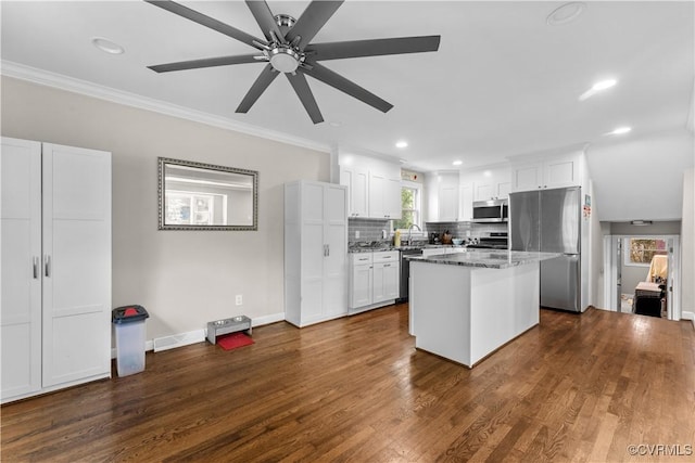 2419 Fon Du Lac Rd, Henrico, VA 23229 - kitchen with appliances with stainless steel finishes, white cabinetry, dark wood-style flooring, a center island, and a ceiling fan