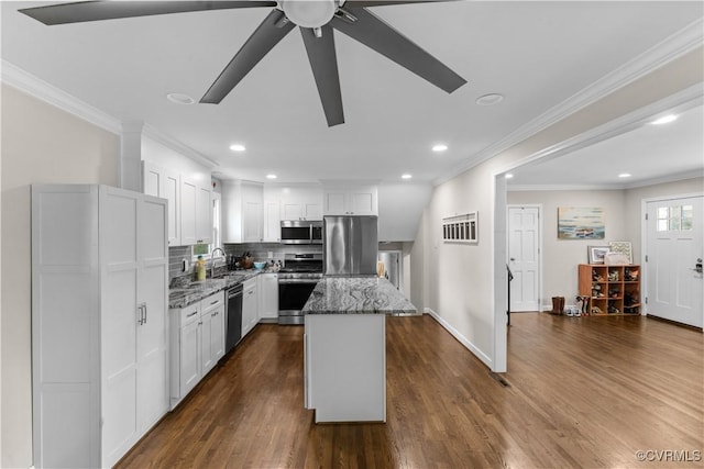 2419 Fon Du Lac Rd, Henrico, VA 23229 - kitchen with appliances with stainless steel finishes, stone countertops, a kitchen island, dark wood-type flooring, and white cabinetry
