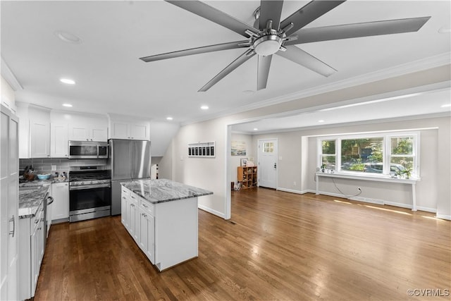 2419 Fon Du Lac Rd, Henrico, VA 23229 - kitchen featuring stainless steel appliances, a kitchen island, light stone countertops, crown molding, and recessed lighting
