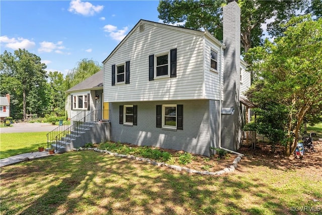2419 Fon Du Lac Rd, Henrico, VA 23229 - tri-level home with a chimney, a front lawn, and brick siding