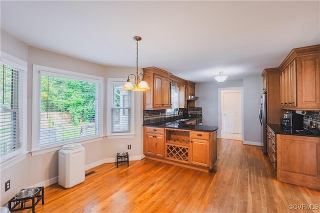 12703 Kelsey Pointe Ct, Chester, VA 23831 - kitchen with dark countertops, tasteful backsplash, light wood-type flooring, and freestanding refrigerator