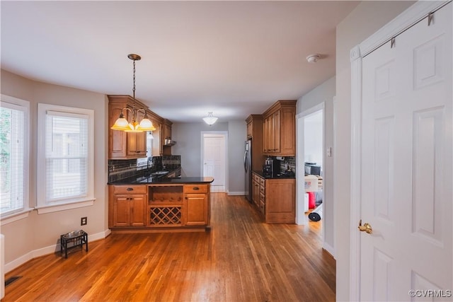 12703 Kelsey Pointe Ct, Chester, VA 23831 - kitchen with dark countertops, backsplash, dark wood-style floors, and brown cabinetry