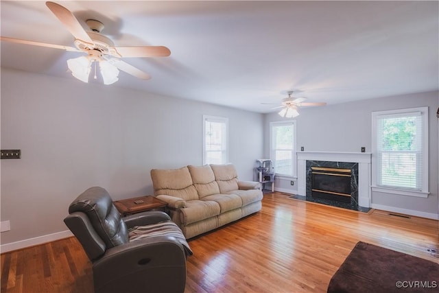 12703 Kelsey Pointe Ct, Chester, VA 23831 - living area featuring a ceiling fan, healthy amount of natural light, wood finished floors, and a premium fireplace
