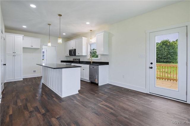 1175 Anderson Hwy, Cumberland, VA 23040 - kitchen featuring stainless steel appliances, dark countertops, dark wood-style floors, white cabinets, and a center island