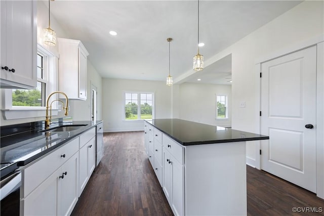 1175 Anderson Hwy, Cumberland, VA 23040 - kitchen with dark countertops, dark wood-style flooring, white dishwasher, white cabinetry, and recessed lighting