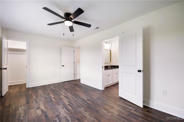 1175 Anderson Hwy, Cumberland, VA 23040 - unfurnished bedroom featuring dark wood-style flooring, a spacious closet, ensuite bath, and ceiling fan