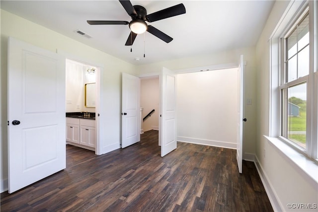 1175 Anderson Hwy, Cumberland, VA 23040 - unfurnished bedroom with dark wood-style flooring, multiple windows, and a ceiling fan