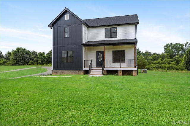 1175 Anderson Hwy, Cumberland, VA 23040 - view of front facade featuring a porch, a front lawn, board and batten siding, and a shingled roof