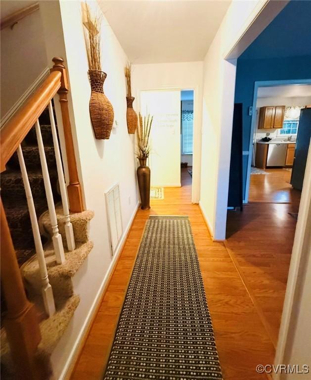 7016 Narragansett Ct, Hanover, VA 23111 - hallway with stairs and light wood finished floors