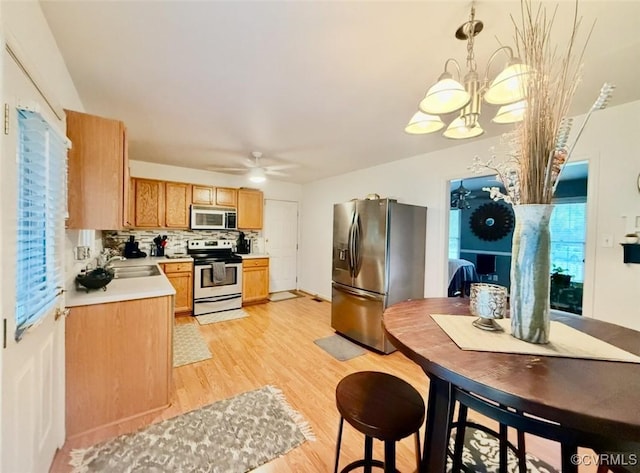 7016 Narragansett Ct, Hanover, VA 23111 - kitchen featuring appliances with stainless steel finishes, light countertops, light wood-style floors, a ceiling fan, and tasteful backsplash