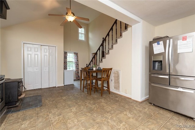9349 Quinnford Blvd, Chesterfield, VA 23237 - kitchen featuring stainless steel fridge, a wood stove, a ceiling fan, and a towering ceiling