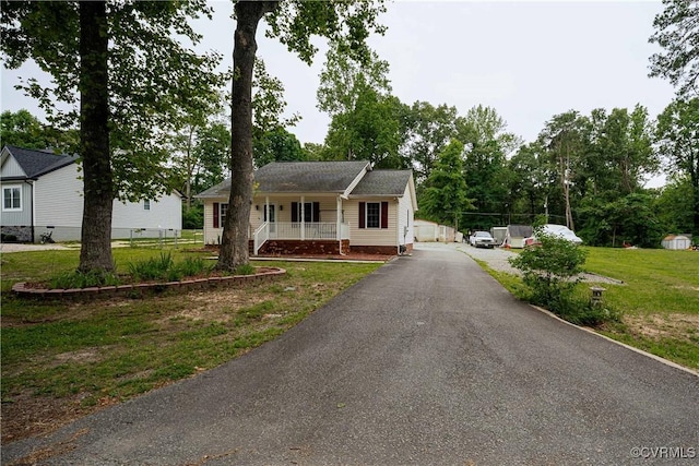 12226 Bristle Cone Ln, Ruther Glen, VA 22546 - single story home with covered porch, asphalt driveway, and a front lawn