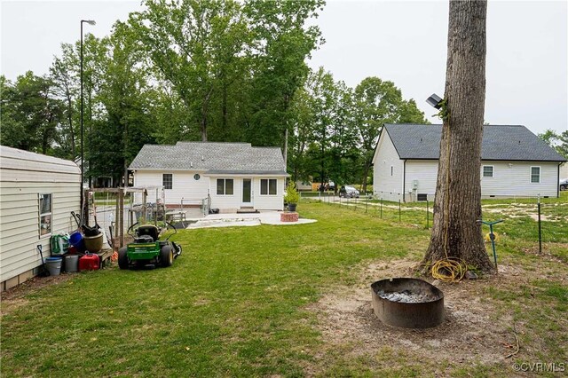 12226 Bristle Cone Ln, Ruther Glen, VA 22546 - fenced backyard featuring an outdoor fire pit and a patio area