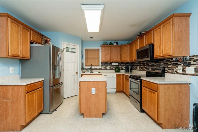 12226 Bristle Cone Ln, Ruther Glen, VA 22546 - kitchen with appliances with stainless steel finishes, light floors, a kitchen island, and backsplash