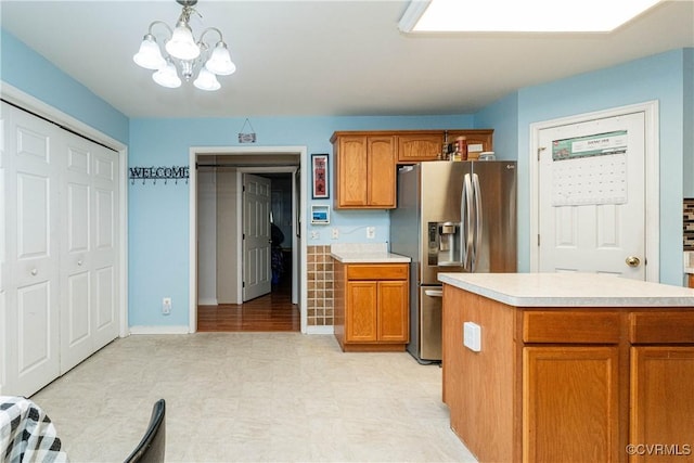 12226 Bristle Cone Ln, Ruther Glen, VA 22546 - kitchen with stainless steel refrigerator with ice dispenser, light countertops, light floors, a chandelier, and brown cabinets