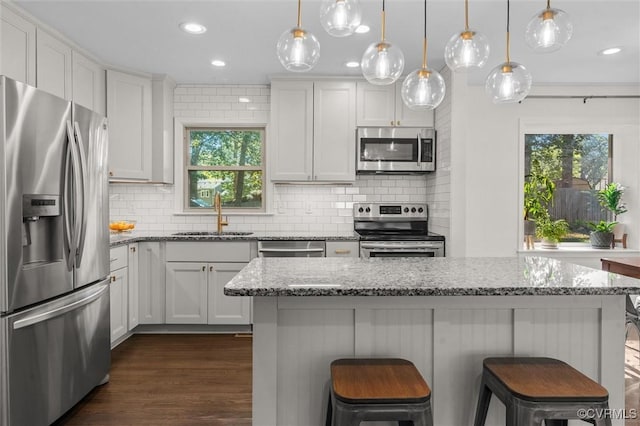 1101 Clearlake Rd, Chesterfield, VA 23236 - kitchen featuring stainless steel appliances, decorative backsplash, a kitchen breakfast bar, recessed lighting, and light stone countertops