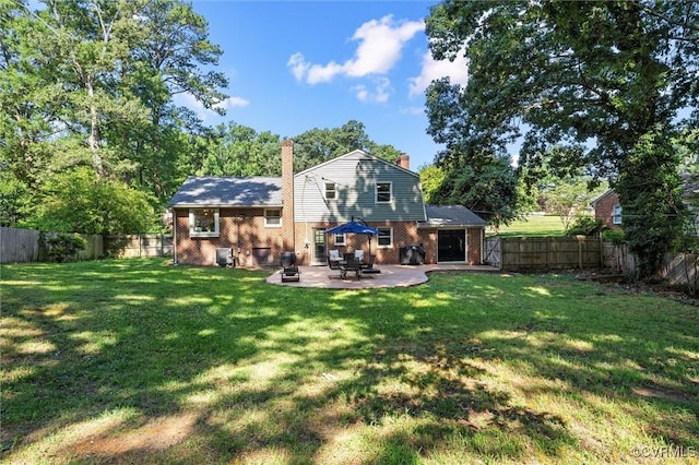 1101 Clearlake Rd, Chesterfield, VA 23236 - back of property with a chimney, brick siding, a patio area, a fenced backyard, and view of wooded area