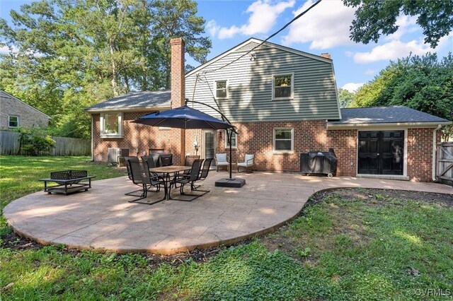 1101 Clearlake Rd, Chesterfield, VA 23236 - rear view of property featuring a chimney, a patio area, brick siding, and a fire pit