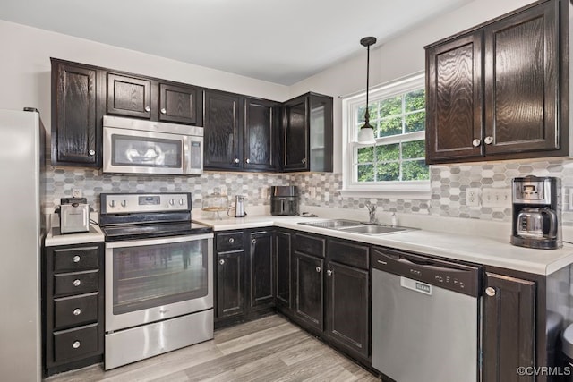 225 Scotch Pine Dr, Sandston, VA 23150 - kitchen featuring stainless steel appliances, decorative backsplash, light wood-type flooring, and light countertops