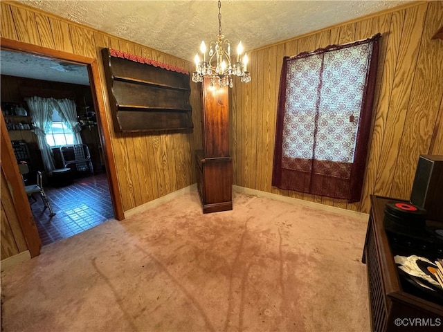 2528 Aldridge Ave, South Chesterfield, VA 23834 - unfurnished dining area with a chandelier, a textured ceiling, and wood walls