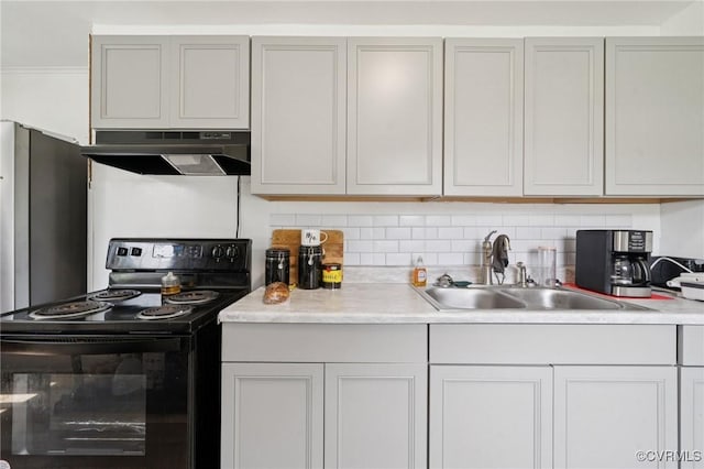 1403 Miles Ave, Hopewell, VA 23860 - kitchen with black electric range, under cabinet range hood, light countertops, and backsplash