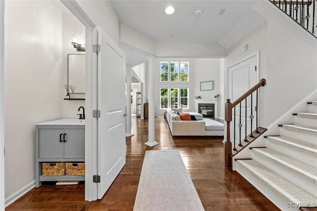 3057 Hunton Cottage Ln, Glen Allen, VA 23059 - entrance foyer featuring stairs, dark wood-style floors, ornate columns, and a glass covered fireplace