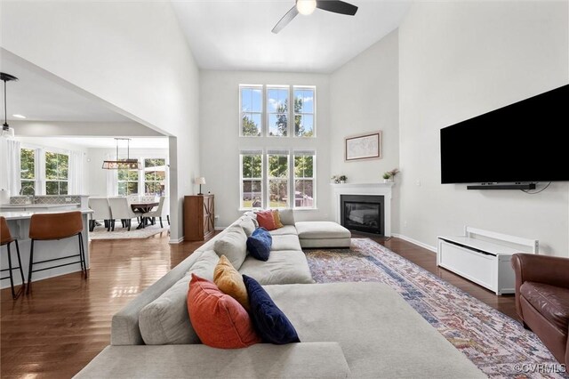 3057 Hunton Cottage Ln, Glen Allen, VA 23059 - living room with high vaulted ceiling, ceiling fan, dark wood-style flooring, and a glass covered fireplace