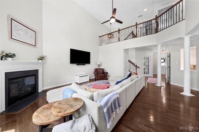 3057 Hunton Cottage Ln, Glen Allen, VA 23059 - living area with decorative columns, stairs, a ceiling fan, wood finished floors, and a high ceiling