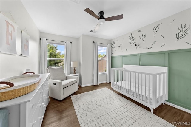 3057 Hunton Cottage Ln, Glen Allen, VA 23059 - bedroom with dark wood-style floors, a crib, and a ceiling fan
