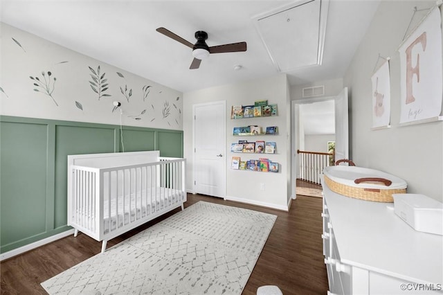3057 Hunton Cottage Ln, Glen Allen, VA 23059 - bedroom with attic access, a nursery area, dark wood-type flooring, a decorative wall, and a ceiling fan