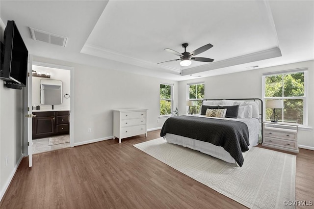 3057 Hunton Cottage Ln, Glen Allen, VA 23059 - bedroom with a raised ceiling, multiple windows, and wood finished floors