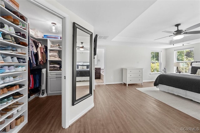 3057 Hunton Cottage Ln, Glen Allen, VA 23059 - bedroom featuring a tray ceiling, wood finished floors, a spacious closet, and a closet