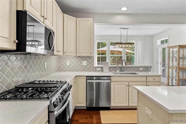 3057 Hunton Cottage Ln, Glen Allen, VA 23059 - kitchen with stainless steel appliances, cream cabinetry, dark wood finished floors, healthy amount of natural light, and recessed lighting