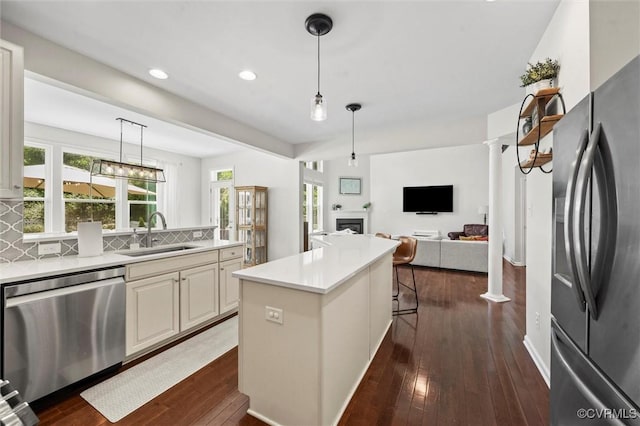 3057 Hunton Cottage Ln, Glen Allen, VA 23059 - kitchen featuring stainless steel appliances, a fireplace, dark wood-style floors, recessed lighting, and backsplash