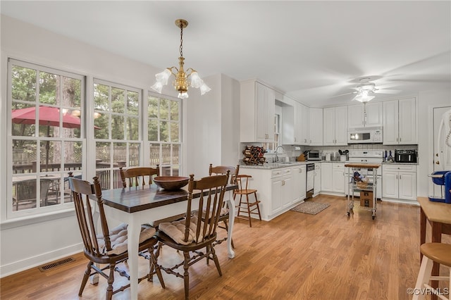 1406 Walton Bluff Ter, Midlothian, VA 23114 - dining room with light wood-type flooring, a chandelier, and a ceiling fan