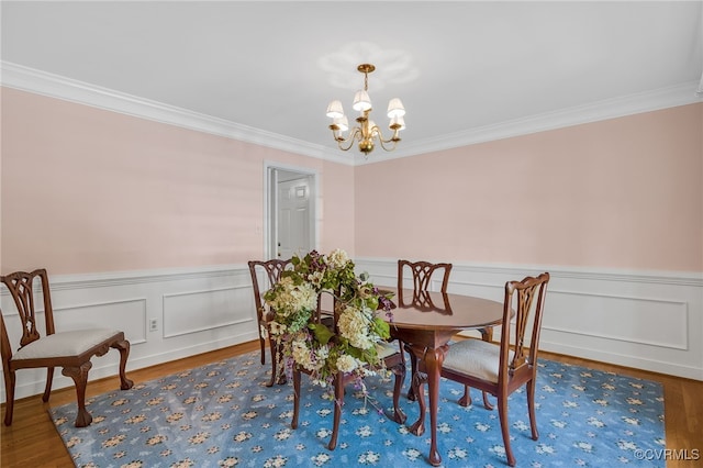 1406 Walton Bluff Ter, Midlothian, VA 23114 - dining area featuring a chandelier, crown molding, wood finished floors, and a wainscoted wall