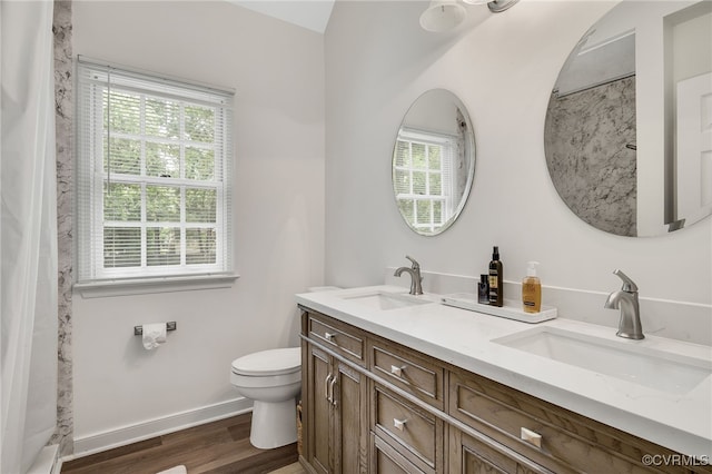 1406 Walton Bluff Ter, Midlothian, VA 23114 - bathroom featuring healthy amount of natural light, double vanity, wood finished floors, and a shower with shower curtain