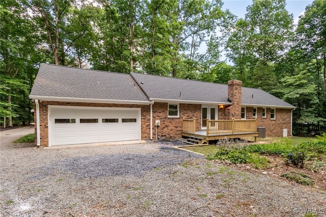 4712 Kyloe Ln, Moseley, VA 23120 - ranch-style house with gravel driveway, a garage, a wooden deck, a chimney, and roof with shingles