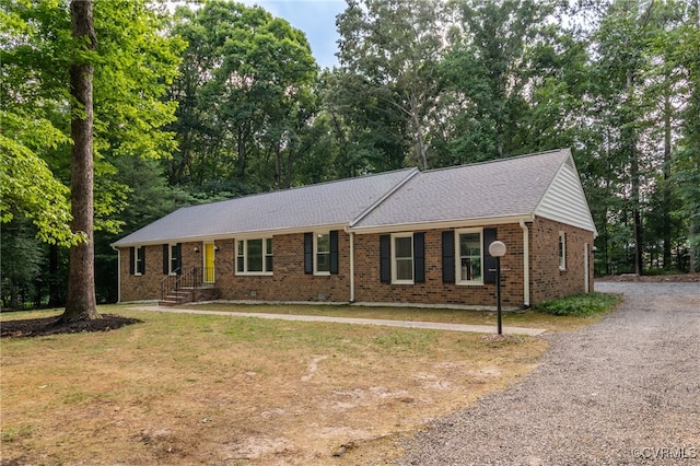4712 Kyloe Ln, Moseley, VA 23120 - ranch-style home featuring driveway, brick siding, a shingled roof, view of wooded area, and a front lawn