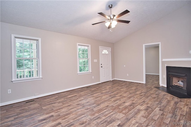 6434 Anderson Hwy, Powhatan, VA 23139 - unfurnished living room with wood finished floors, a ceiling fan, healthy amount of natural light, lofted ceiling, and a textured ceiling