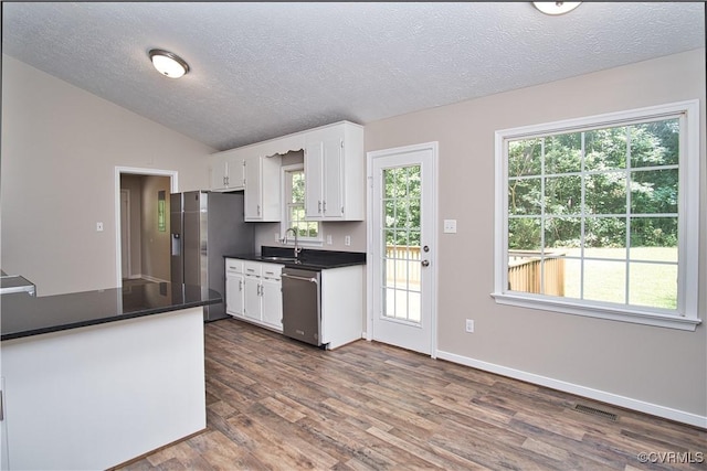 6434 Anderson Hwy, Powhatan, VA 23139 - kitchen featuring appliances with stainless steel finishes, dark countertops, a textured ceiling, white cabinetry, and dark wood-style flooring
