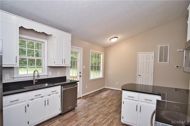 6434 Anderson Hwy, Powhatan, VA 23139 - kitchen with stainless steel dishwasher, dark countertops, white cabinetry, lofted ceiling, and a textured ceiling