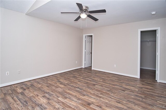 6434 Anderson Hwy, Powhatan, VA 23139 - unfurnished bedroom featuring wood finished floors, a spacious closet, a ceiling fan, and a closet