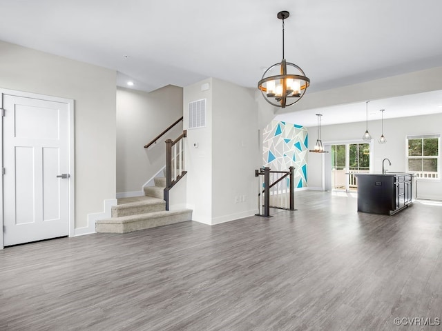 341 Crofton Village Ter Unit Kd, Chesterfield, VA 23114 - unfurnished living room with dark wood finished floors and a chandelier