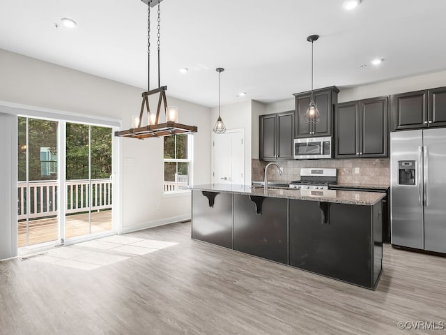 341 Crofton Village Ter Unit Kd, Chesterfield, VA 23114 - kitchen featuring stainless steel appliances, light wood-style floors, decorative backsplash, a breakfast bar, and recessed lighting