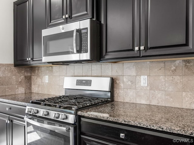 341 Crofton Village Ter Unit Kd, Chesterfield, VA 23114 - kitchen with stainless steel appliances, dark stone countertops, dark cabinets, and tasteful backsplash