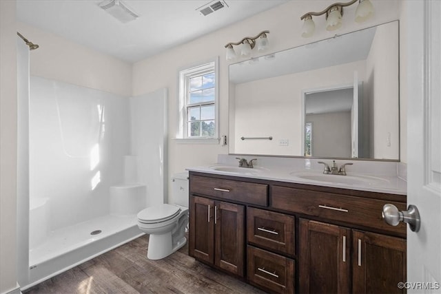 11325 Webb Rd, Disputanta, VA 23842 - bathroom with double vanity, plenty of natural light, wood finished floors, and a shower