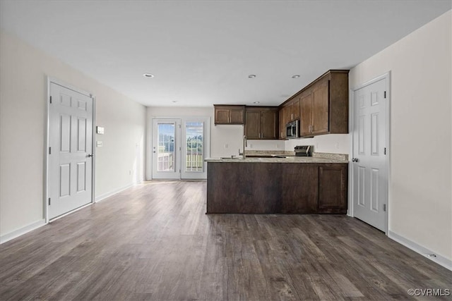 11325 Webb Rd, Disputanta, VA 23842 - kitchen featuring appliances with stainless steel finishes, dark wood-style flooring, light countertops, dark brown cabinets, and a peninsula